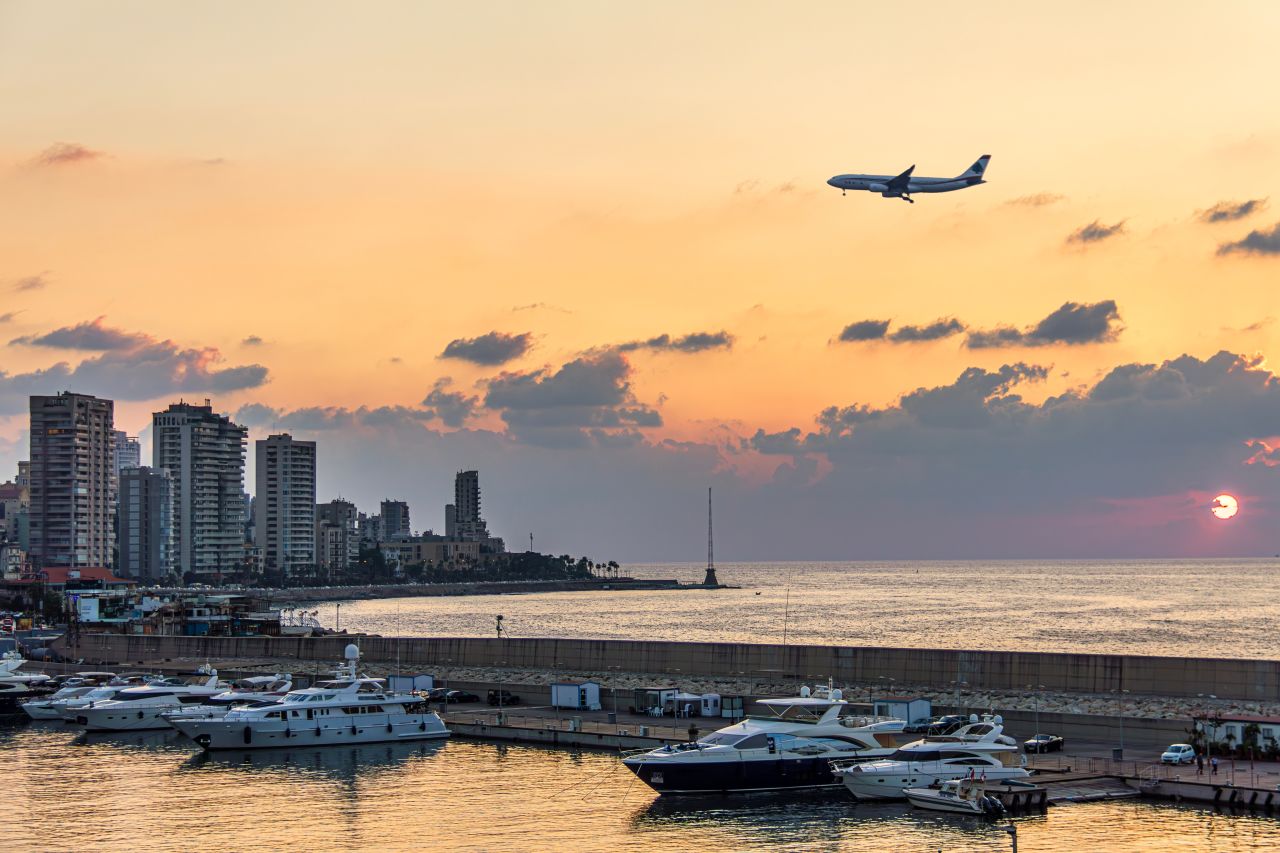 Commercial airplane approaching Tel Aviv at sunset as Middle East airspace disruptions affect American departures